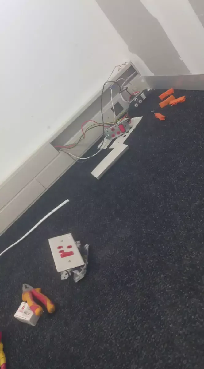 Electrical installation work in progress showing wiring and fixtures
